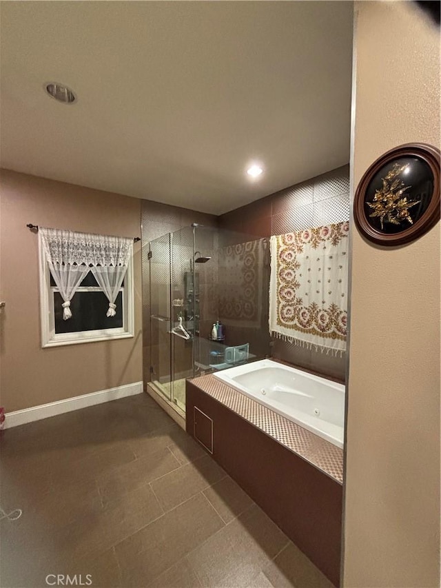 bathroom featuring tile patterned flooring and plus walk in shower