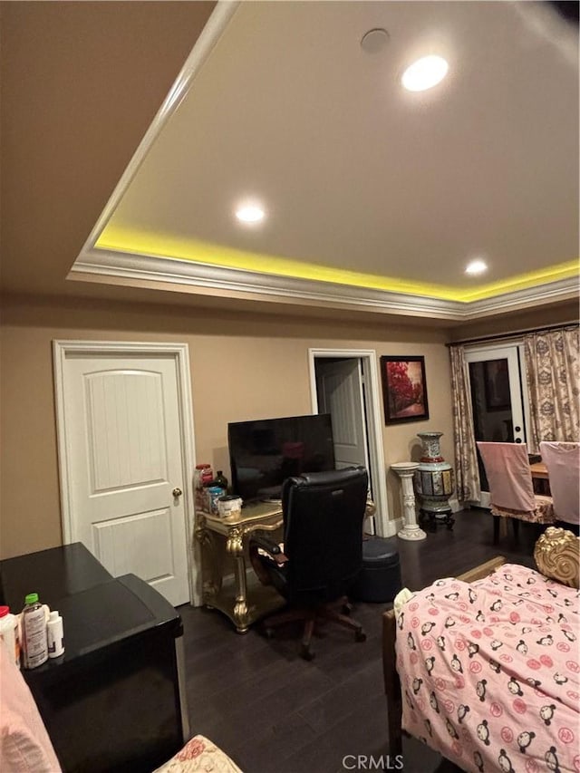 bedroom featuring hardwood / wood-style floors and a tray ceiling