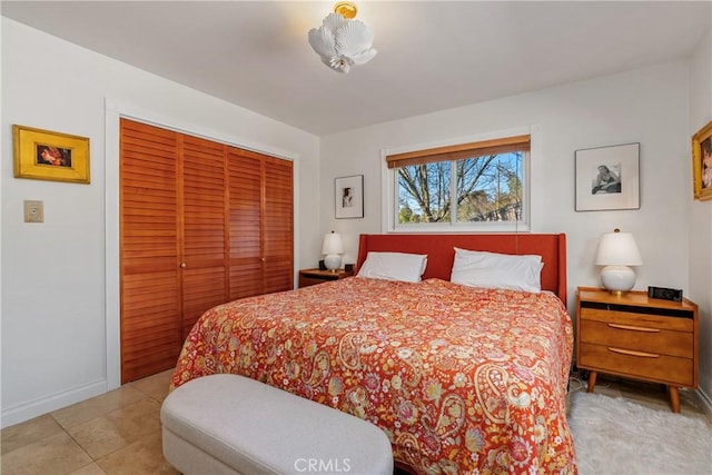 bedroom featuring a closet and light tile patterned floors