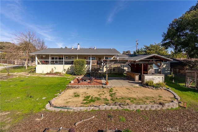 rear view of house featuring a lawn