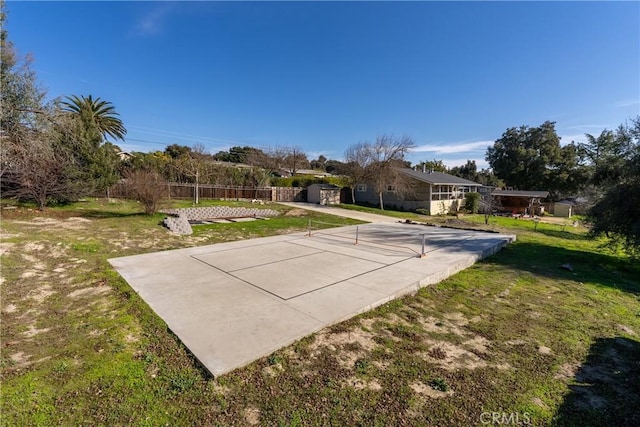 view of community featuring a yard and basketball hoop