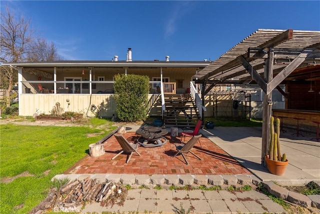 back of house featuring an outdoor fire pit, a pergola, a patio area, and a yard