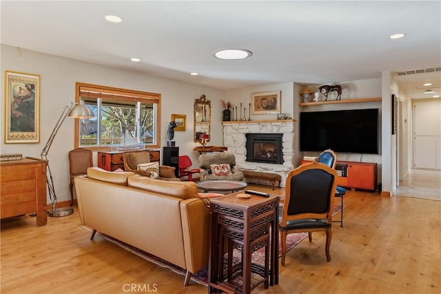 living room featuring a fireplace and light hardwood / wood-style floors