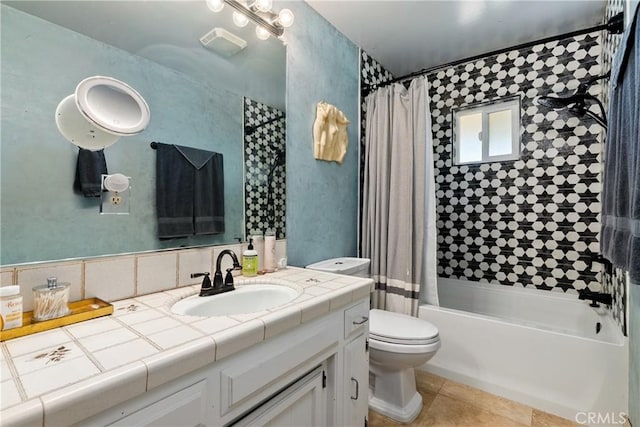 full bathroom with tile patterned flooring, toilet, vanity, and shower / tub combo with curtain