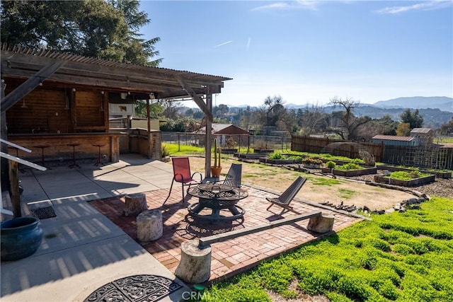 view of patio / terrace with a pergola, a mountain view, and a bar