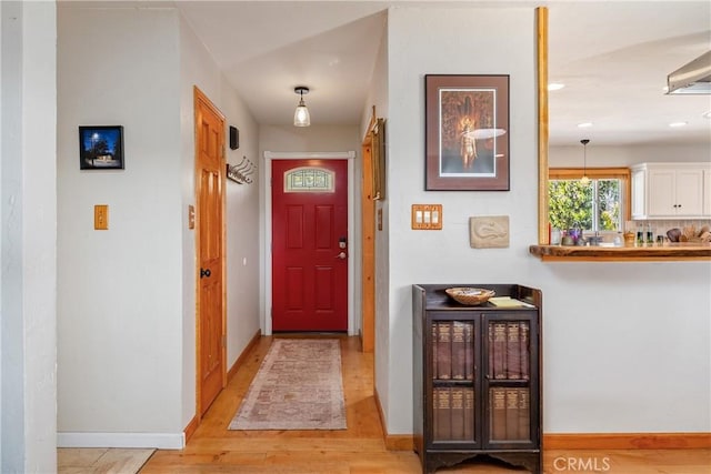 doorway with light wood-type flooring