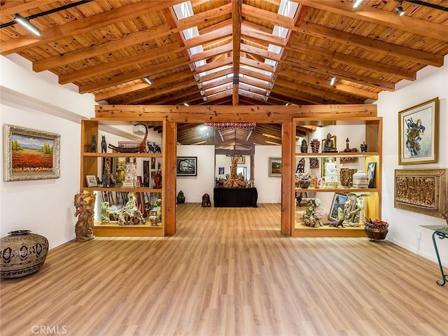 interior space with wood ceiling, light hardwood / wood-style flooring, and lofted ceiling with beams