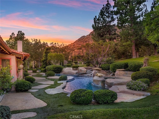 view of home's community featuring a lawn and a mountain view