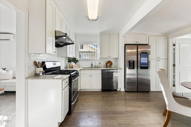 kitchen with white cabinetry, stainless steel appliances, decorative backsplash, dark hardwood / wood-style floors, and sink