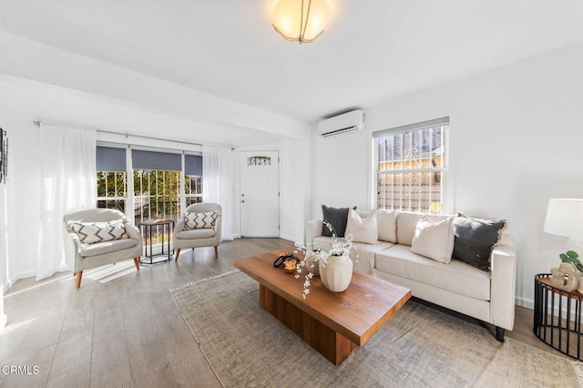 living room with hardwood / wood-style floors and a wall mounted air conditioner