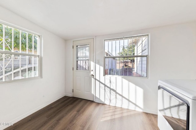 spare room with washing machine and dryer and dark wood-type flooring