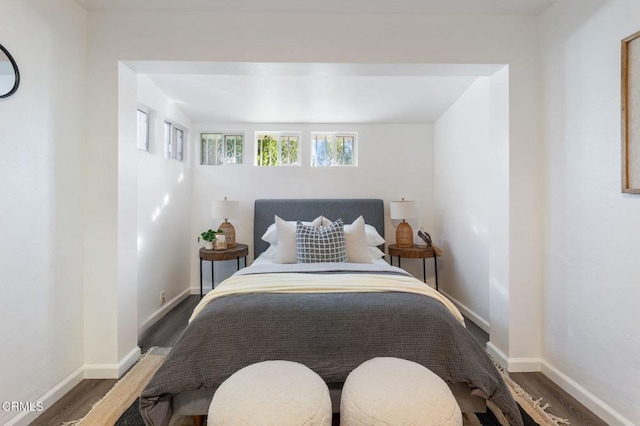 bedroom with dark wood-type flooring