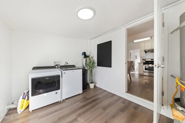 laundry area featuring wood-type flooring and separate washer and dryer