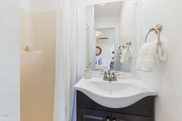 bathroom with vanity and a wall mounted air conditioner