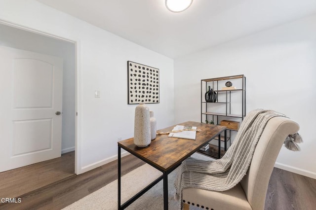 home office with dark hardwood / wood-style flooring