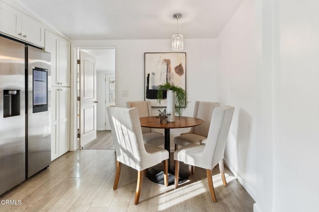 dining area featuring light wood-type flooring