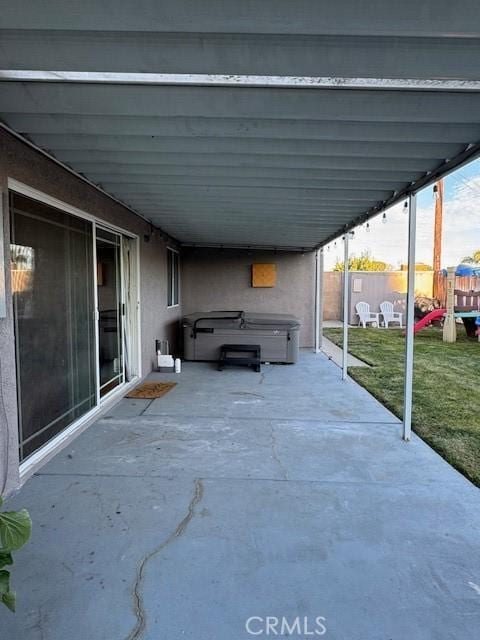 view of patio / terrace with a hot tub