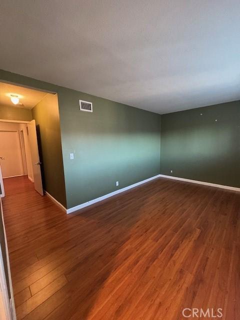 spare room with hardwood / wood-style flooring