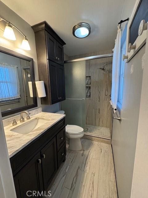 bathroom featuring curtained shower, toilet, and vanity