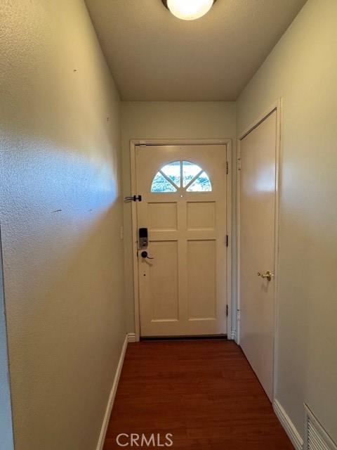 doorway with dark hardwood / wood-style floors