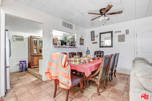 dining room with a wall unit AC and ceiling fan