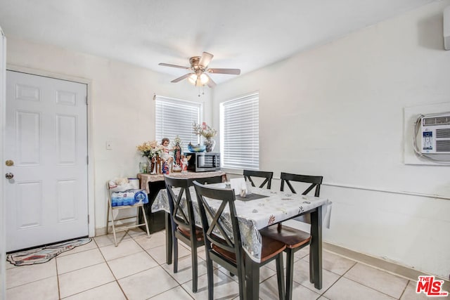 dining room with ceiling fan, light tile patterned floors, and an AC wall unit