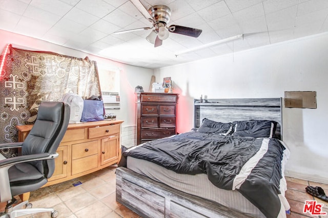 tiled bedroom featuring ceiling fan