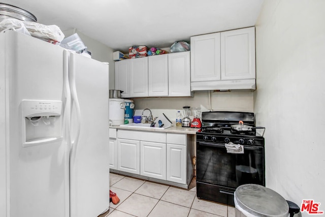 kitchen featuring white cabinets, sink, white fridge with ice dispenser, and black range with gas cooktop