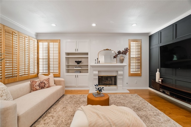 living room with crown molding and light hardwood / wood-style flooring