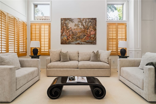 living room with a high ceiling and carpet flooring