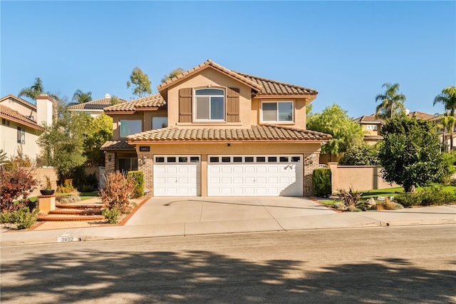 mediterranean / spanish-style home with a garage