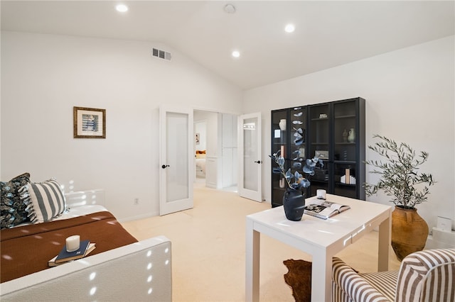 office area featuring light carpet, lofted ceiling, and french doors