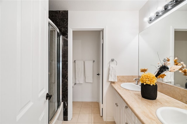 bathroom with combined bath / shower with glass door, tile patterned floors, and vanity