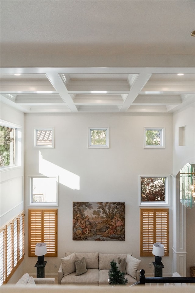 living room featuring a wealth of natural light and beamed ceiling