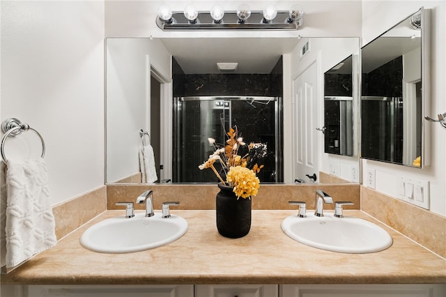 bathroom with an enclosed shower and vanity