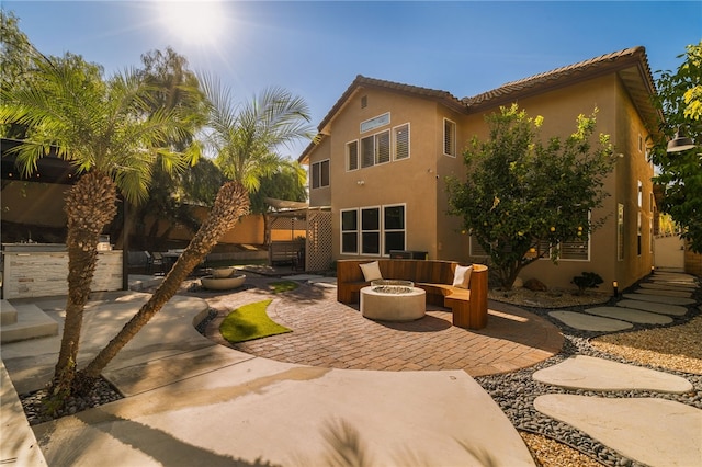 back of house with a patio area and a fire pit