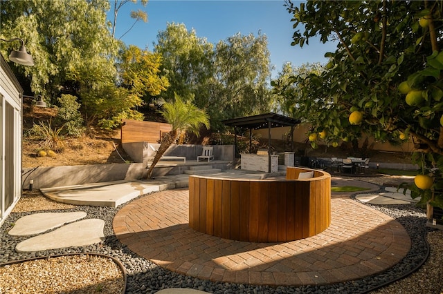 view of patio featuring an outdoor kitchen and a gazebo