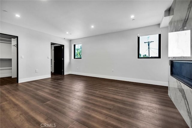 unfurnished living room with dark hardwood / wood-style flooring