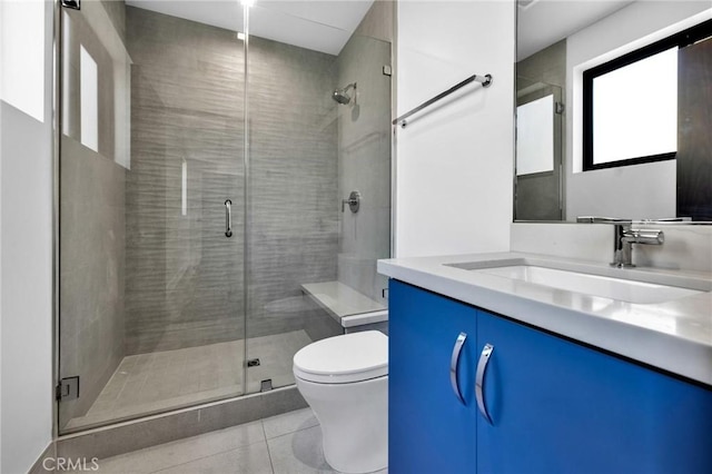 bathroom with toilet, vanity, an enclosed shower, and tile patterned floors