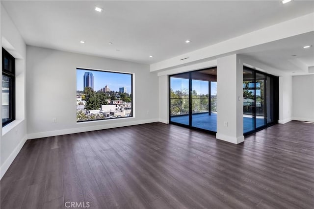 unfurnished living room featuring dark hardwood / wood-style floors