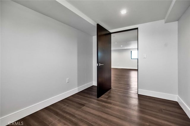 unfurnished room featuring dark hardwood / wood-style floors