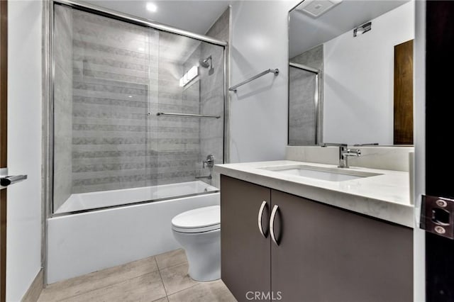 full bathroom with toilet, vanity, tile patterned flooring, and shower / bath combination with glass door