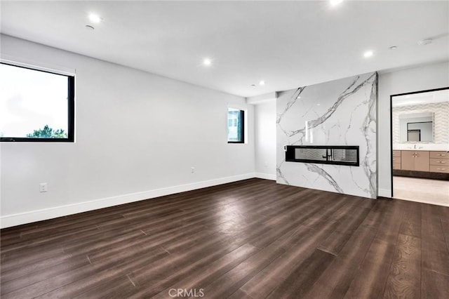 unfurnished living room featuring hardwood / wood-style floors and a high end fireplace