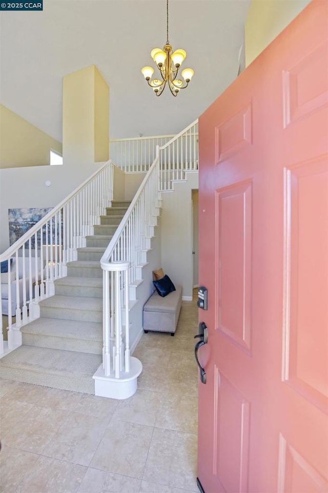 tiled foyer with a high ceiling and an inviting chandelier