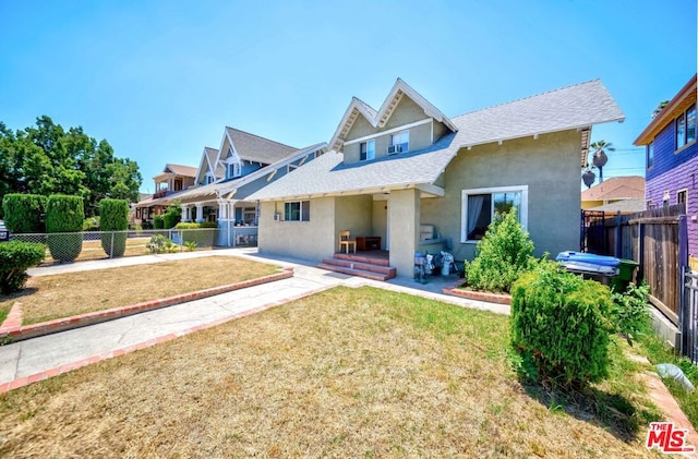 rear view of house with a yard