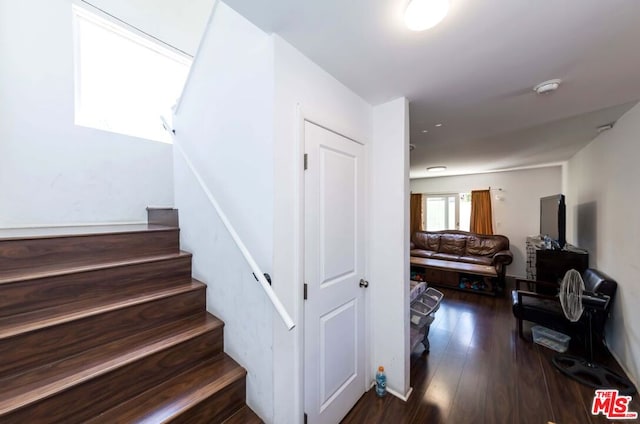 stairs featuring hardwood / wood-style floors