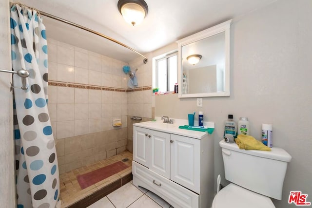 bathroom with tile patterned floors, toilet, walk in shower, and vanity