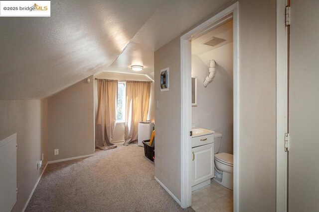 bonus room featuring light carpet and lofted ceiling