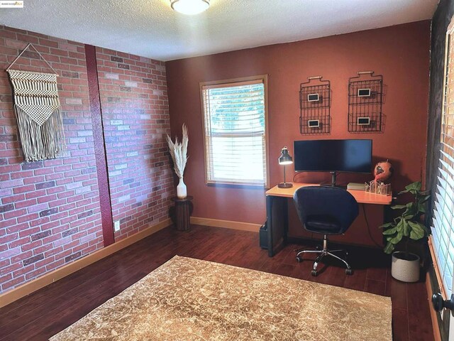 office with a textured ceiling and dark wood-type flooring