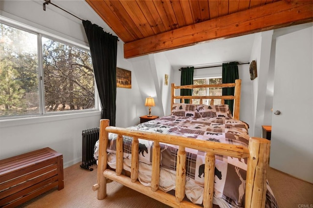 carpeted bedroom featuring beam ceiling, radiator, and wood ceiling